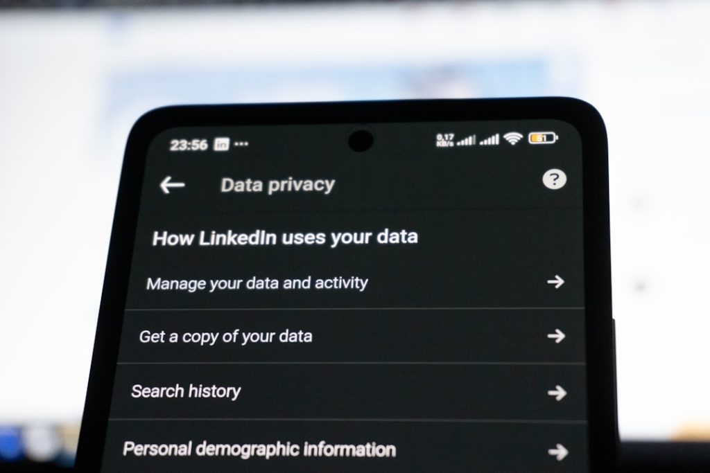 A LinkedIn Data privacy settings menu open on a smartphone screen, showing options for managing your data and activity, search history, and personal demographic information.