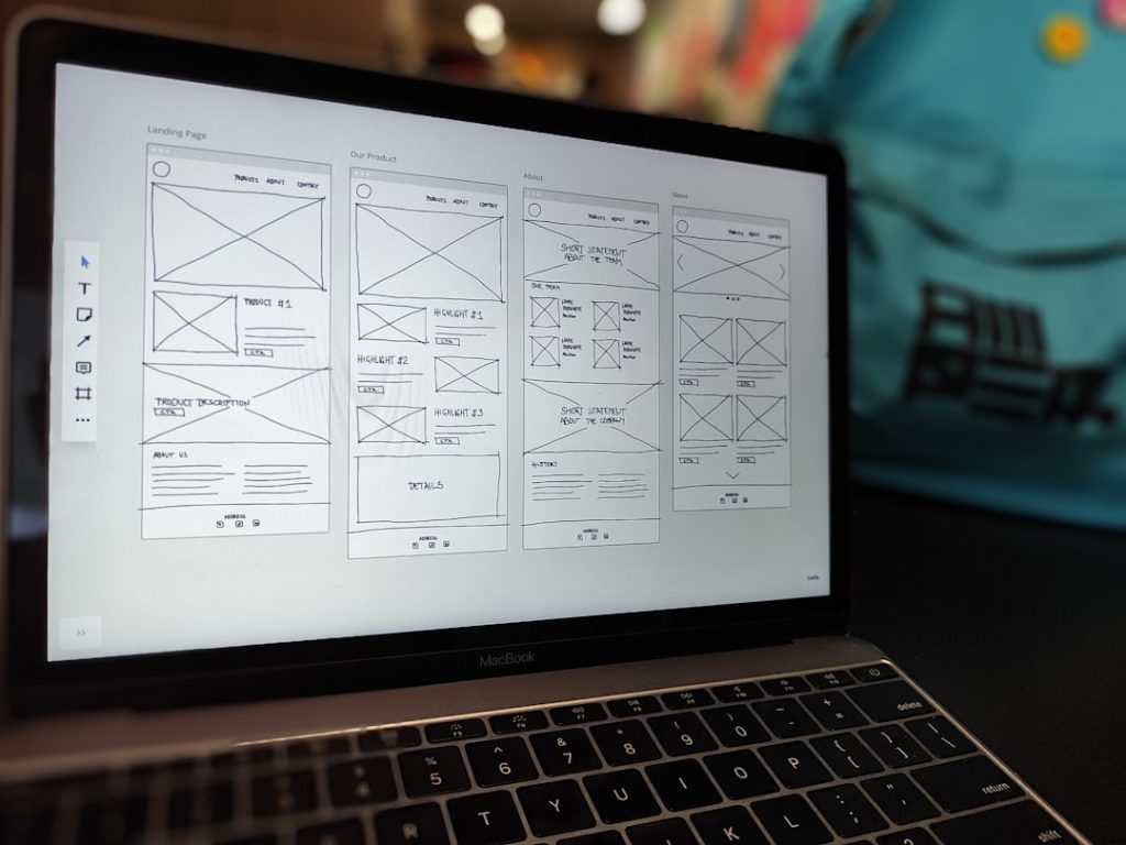 A website wireframe on a laptop screen, representing building a personal website to stand out in a job search.
